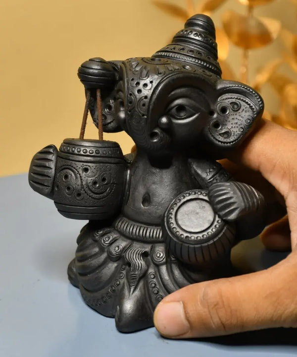 Serene Rhythms: Black Terracotta Ganesh Playing Iktara and Tabla — image 2