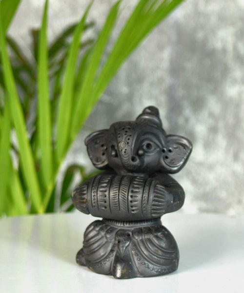 Melodic Mastery: Black Terracotta Ganesh and Tabla Ensemble