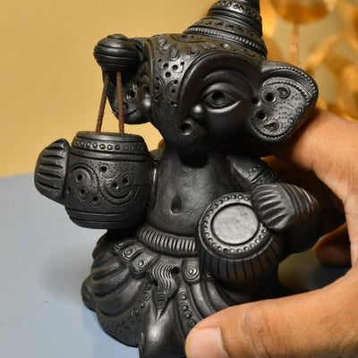 Serene Rhythms: Black Terracotta Ganesh Playing Iktara and Tabla