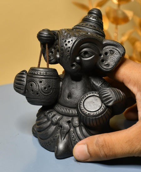 Serene Rhythms: Black Terracotta Ganesh Playing Iktara and Tabla