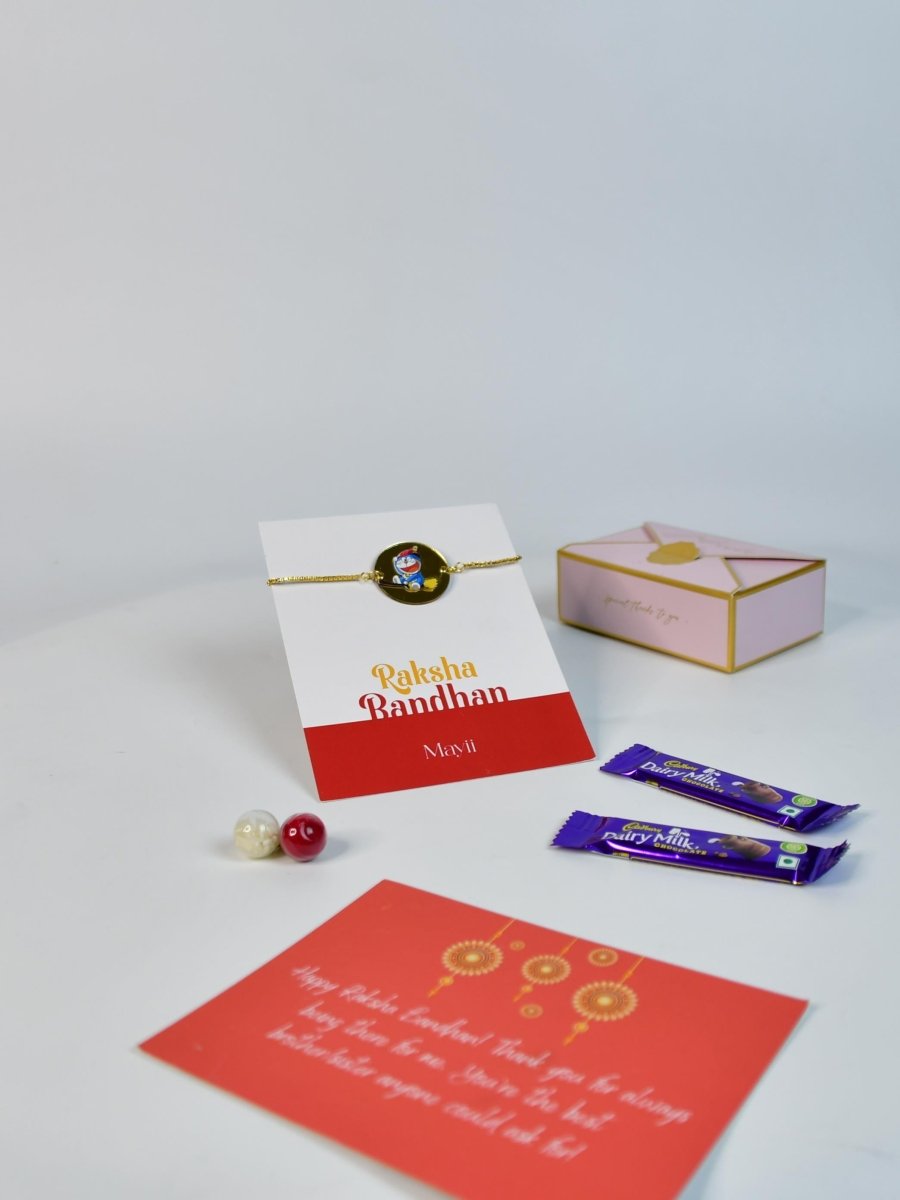 Sowpeace Exquisite Doraemon Rakhi Pack of 1 with Roli Chawal Thali, two Chocolates, and Greeting card combo for Raksha Bandhan and Gifting - Rakhi - Sowpeace - Default Title - RAK - DORA - HND - P2 - Sowpeace