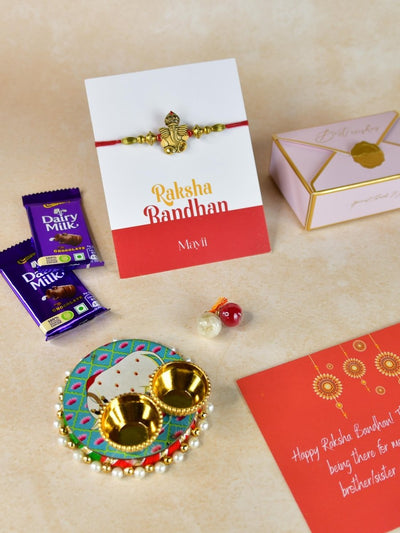 Sowpeace Exquisite Golden Ganesha Rakhi Pack of 1 with Roli Chawal Thali, Chocolates, and Greeting card combo for Raksha Bandhan and Gifting