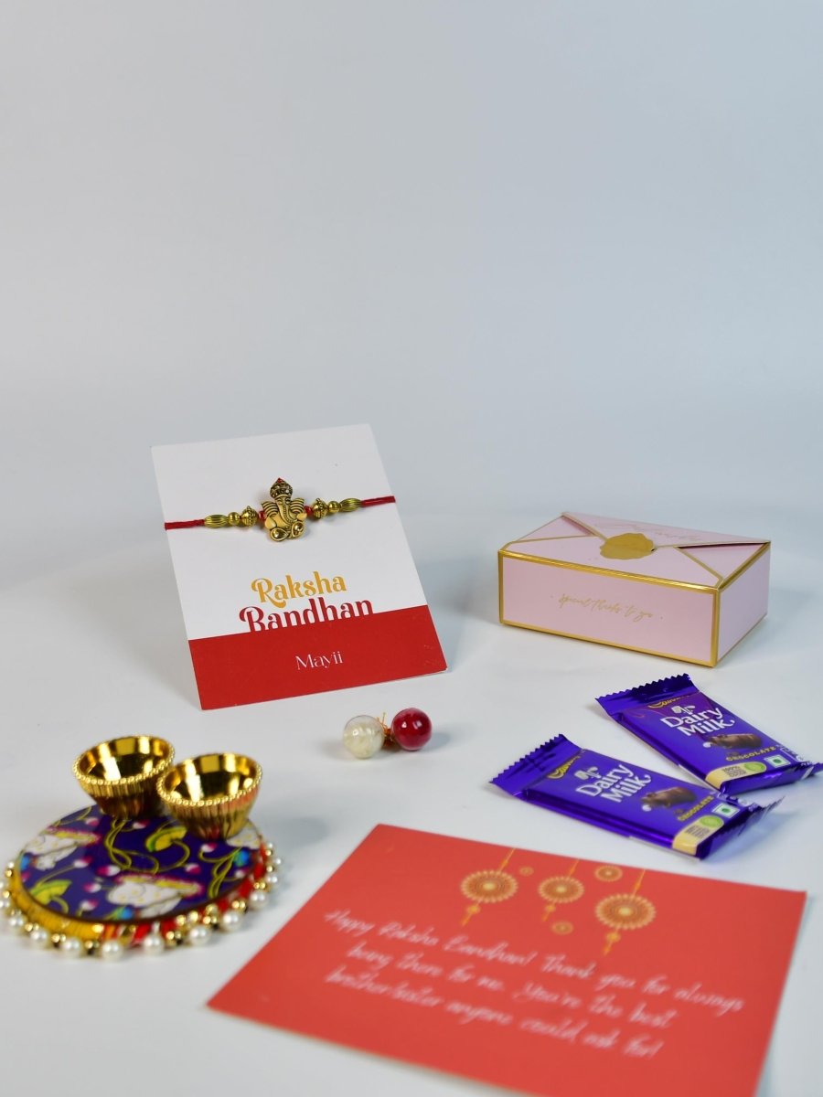 Sowpeace Exquisite Golden Ganesha Rakhi Pack of 1 with Roli Chawal Thali, Chocolates, and Greeting card combo for Raksha Bandhan and Gifting