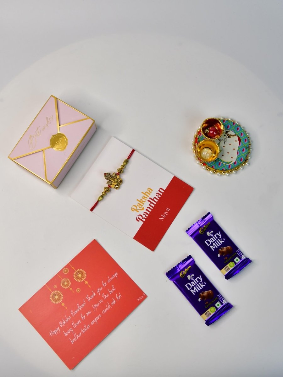 Sowpeace Exquisite Golden Ganesha Rakhi Pack of 1 with Roli Chawal Thali, Chocolates, and Greeting card combo for Raksha Bandhan and Gifting - Rakhi - Sowpeace - Sowpeace Exquisite Golden Ganesha Rakhi Pack of 1 with Roli Chawal Thali, Chocolates, and Greeting card combo for Raksha Bandhan and Gifting - RAK - GNS - HND - P3 - Sowpeace