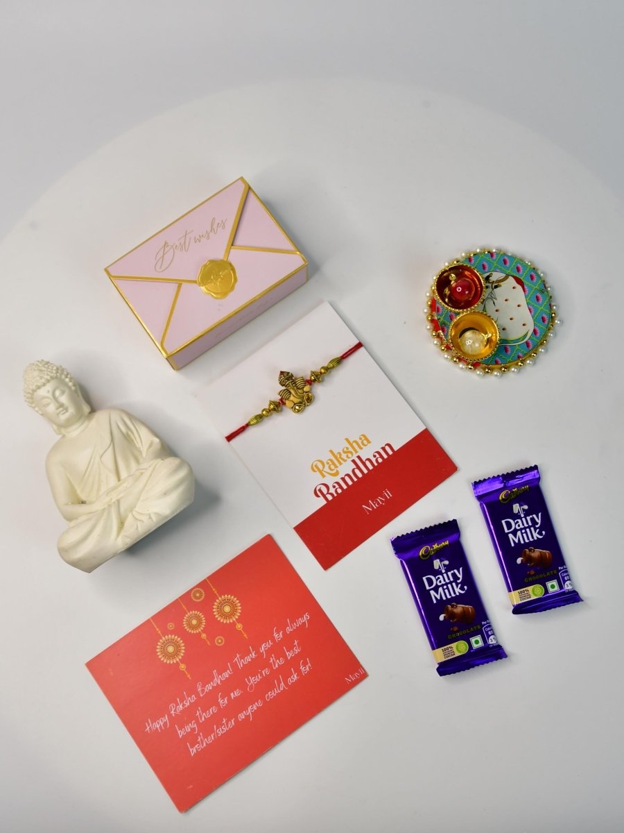 Sowpeace Exquisite Golden Ganesha Rakhi Pack of 1 with Roli Chawal Thali, Chocolates, Buddha and Greeting card combo for Raksha Bandhan and Gifting