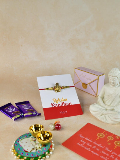 Sowpeace Exquisite Golden Ganesha Rakhi Pack of 1 with Roli Chawal Thali, Chocolates, Buddha and Greeting card combo for Raksha Bandhan and Gifting