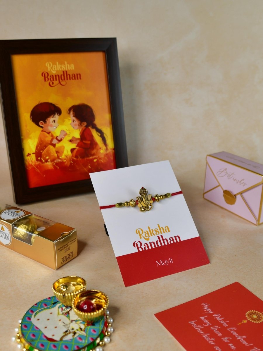 Sowpeace Exquisite Golden Ganesha Rakhi Pack of 1 with Roli Chawal Thali, Chocolates, Photo Frame and Greeting card combo for Raksha Bandhan and Gifting - Rakhi - Sowpeace - Default Title - RAK - GNS - HND - P6 - Sowpeace