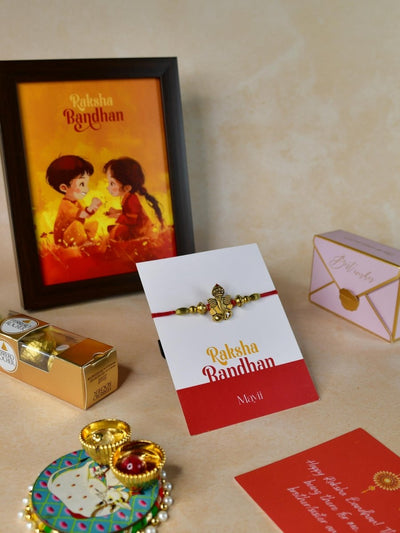 Sowpeace Exquisite Golden Ganesha Rakhi Pack of 1 with Roli Chawal Thali, Chocolates, Photo Frame and Greeting card combo for Raksha Bandhan and Gifting