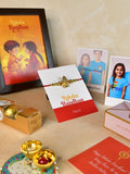 Sowpeace Exquisite Golden Ganesha Rakhi Pack of 1 with Roli Chawal Thali, Chocolates, Photo Frame, Poloroids and Greeting card combo for Raksha Bandhan and Gifting - Rakhi - Sowpeace - Default Title - RAK - GNS - HND - P7 - Sowpeace