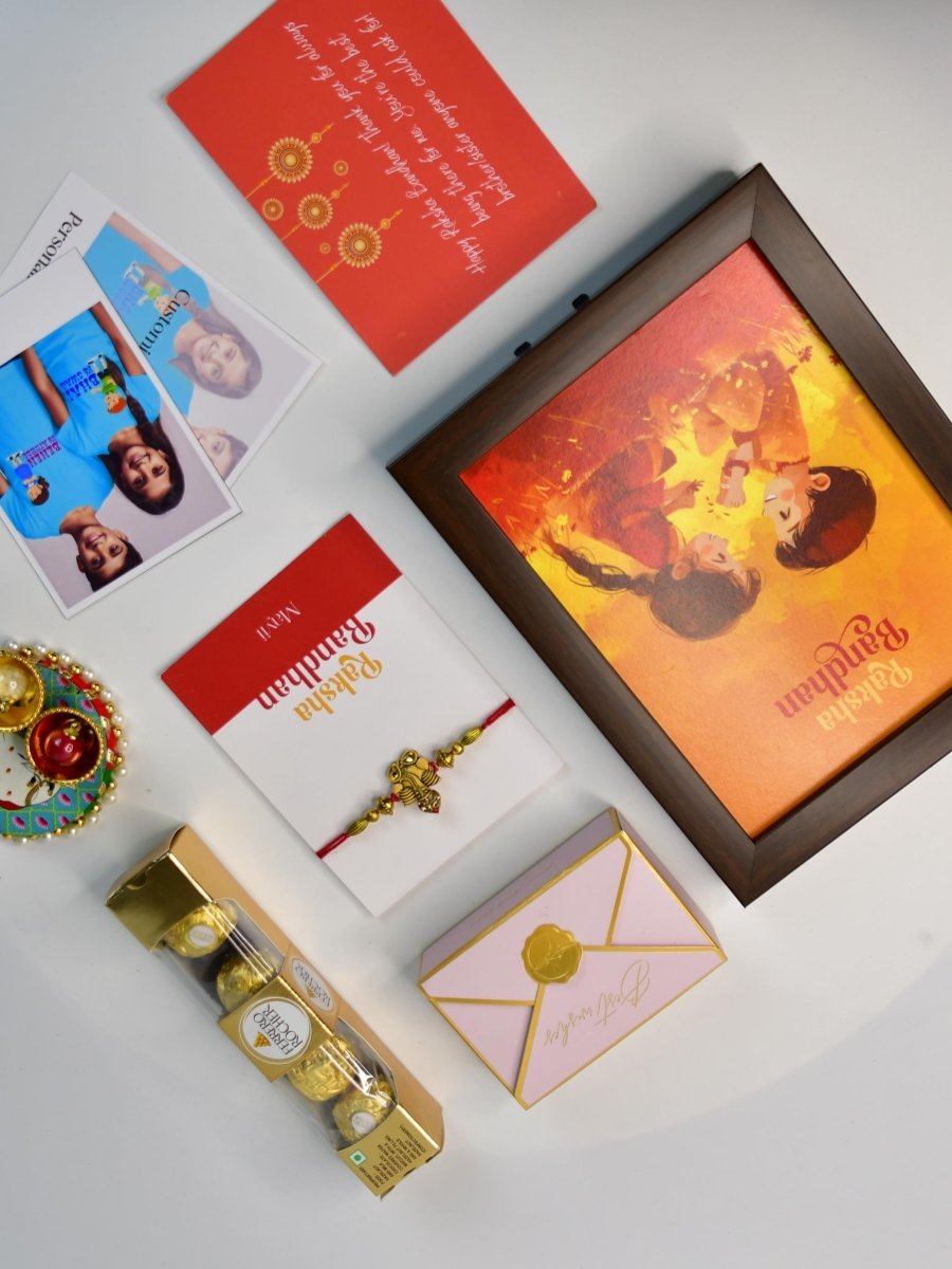 Sowpeace Exquisite Golden Ganesha Rakhi Pack of 1 with Roli Chawal Thali, Chocolates, Photo Frame, Poloroids and Greeting card combo for Raksha Bandhan and Gifting - Rakhi - Sowpeace - Sowpeace Exquisite Golden Ganesha Rakhi Pack of 1 with Roli Chawal Thali, Chocolates, Photo Frame, Poloroids and Greeting card combo for Raksha Bandhan and Gifting - RAK - GNS - HND - P7 - Sowpeace