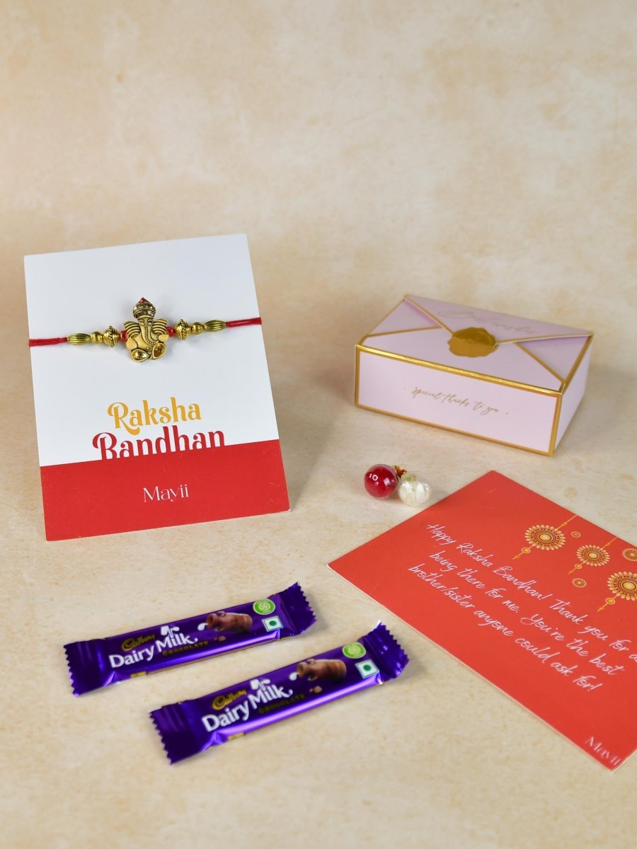 Sowpeace Exquisite Golden Ganesha Rakhi Pack of 1 with Roli Chawal Thali, two Chocolates, and Greeting card combo for Raksha Bandhan and Gifting