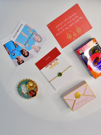 Sowpeace Exquisite Peacock Rakhi Pack of 1 with Roli Chawal Thali, Chocolates, Poloroids and Greeting card combo for Raksha Bandhan and Gifting