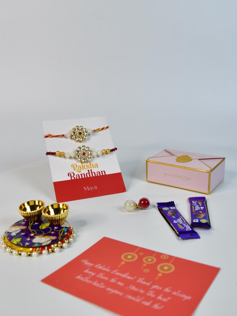 Sowpeace Exquisite Red Centre Flower Rakhi Pack of 1 with Roli Chawal Thali, two Chocolates, and Greeting card combo for Raksha Bandhan and Gifting - Rakhi - Sowpeace - Sowpeace Exquisite Red Centre Flower Rakhi Pack of 1 with Roli Chawal Thali, two Chocolates, and Greeting card combo for Raksha Bandhan and Gifting - RAK - CRFL - HND - P2 - Sowpeace