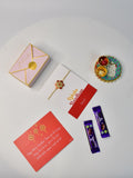 Sowpeace Exquisite Red Flower Rakhi Pack of 1 with Roli Chawal Thali, two Chocolates, and Greeting card combo for Raksha Bandhan and Gifting - Rakhi - Sowpeace - Sowpeace Exquisite Red Flower Rakhi Pack of 1 with Roli Chawal Thali, two Chocolates, and Greeting card combo for Raksha Bandhan and Gifting - RAK - RDFL - HND - P2 - Sowpeace