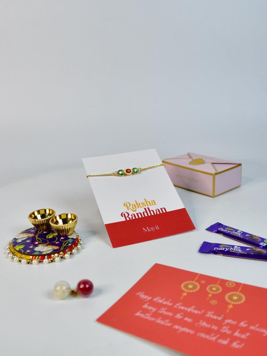 Sowpeace Exquisite Tri Red Green Rakhi Pack of 1 with Roli Chawal Thali, two Chocolates, and Greeting card combo for Raksha Bandhan and Gifting