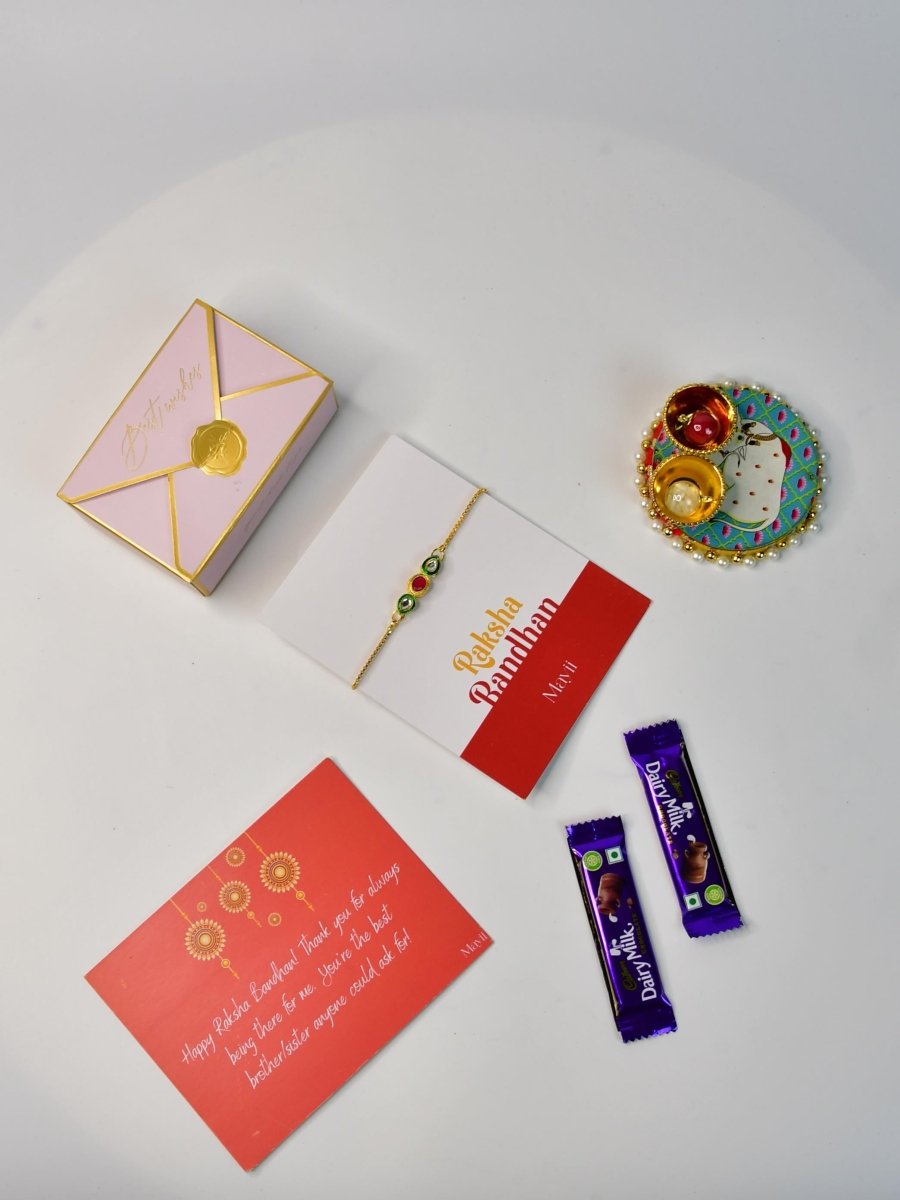 Sowpeace Exquisite Tri Red Green Rakhi Pack of 1 with Roli Chawal Thali, two Chocolates, and Greeting card combo for Raksha Bandhan and Gifting - Rakhi - Sowpeace - Sowpeace Exquisite Tri Red Green Rakhi Pack of 1 with Roli Chawal Thali, two Chocolates, and Greeting card combo for Raksha Bandhan and Gifting - RAK - TRIGR - HND - P2 - Sowpeace